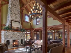 example of timber frame architecture in a home with a fireplace by Millan Architects